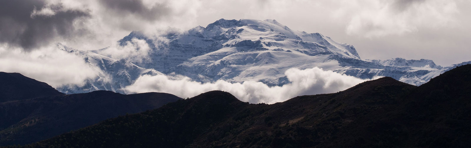 Morning view of mount El Plomo after the first snow of the season from the summit of Pochocón mountain.