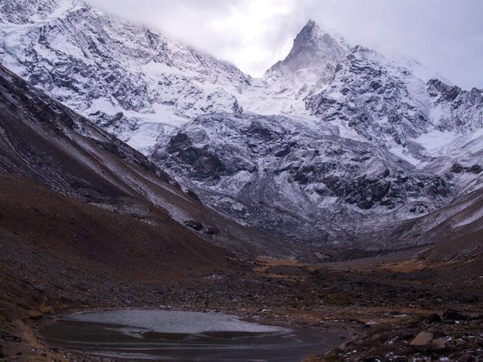 Morales lagoon and the south face of El Morado mountain in El Morado Natural Monument, Chile.