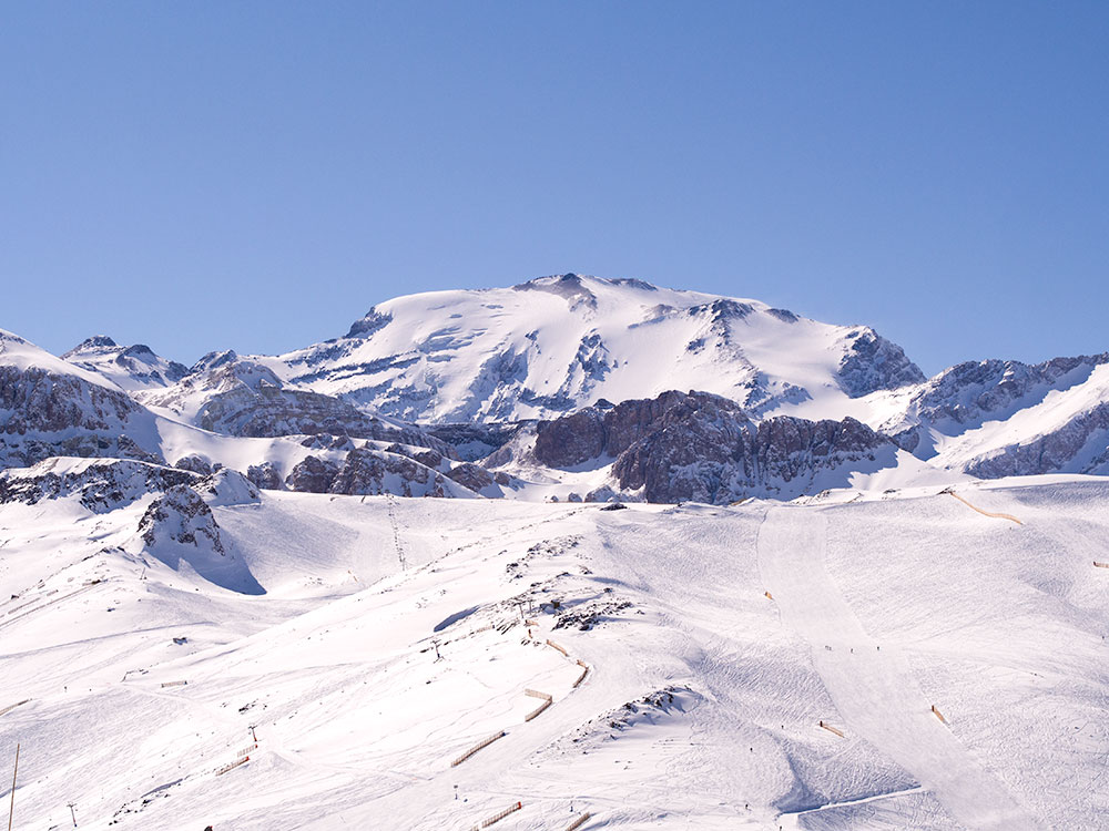 Winter view of La Parva Center ski slopes and mount El Plomo, the highest peak visible from Santiago with and elevation of 5,434m (17,783ft).